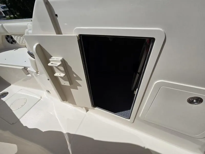 Slide: The Image of 2024 Grady-White Freedom 307 boat storage compartment with open door. - 17