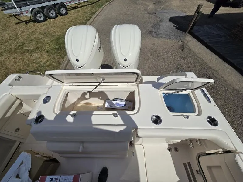 Slide: The Image of 2024 Grady-White Freedom 307 boat with open storage compartments and twin engines. - 20