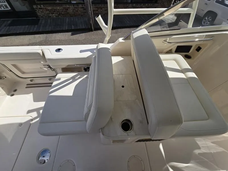 Slide: The Image of 2024 Grady-White Freedom 307 boat interior seating and console. - 21