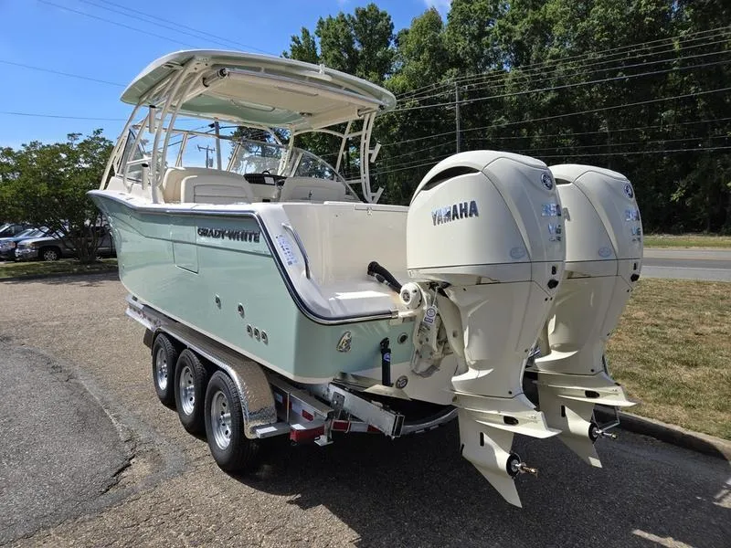 Slide: The Image of 2024 Grady-White Freedom 307 boat with twin Yamaha engines on a trailer. - 3