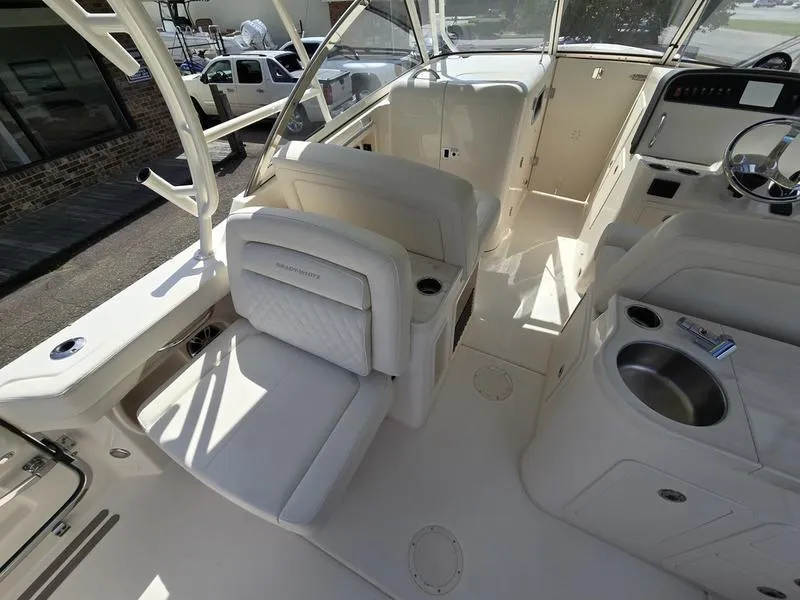 Slide: The Image of 2024 Grady-White Freedom 307 boat interior with helm, seating, and sink. - 7