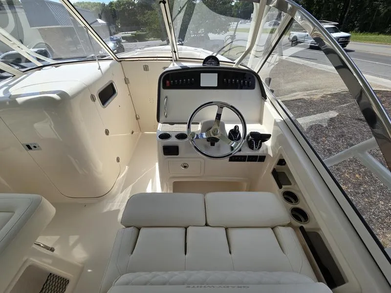 Slide: The Image of 2024 Grady-White Freedom 307 boat interior, helm station with steering wheel and controls. - 9