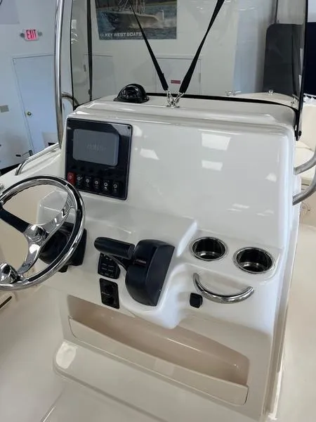 Slide: The Image of 2025 Grady-White Fisherman 180 boat console with steering wheel and controls. - 8