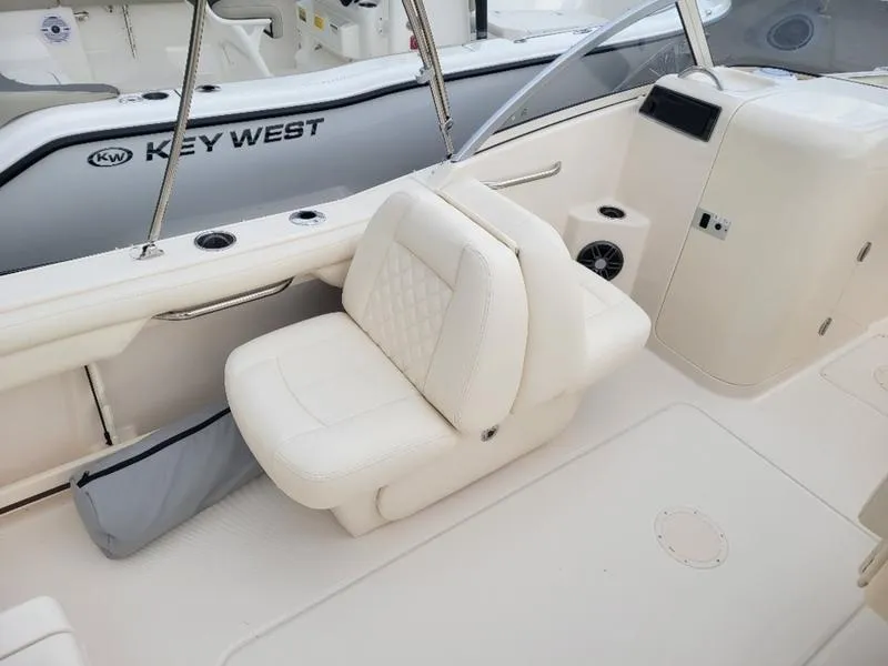 Slide: The Image of 2025 Grady-White Freedom 215 boat interior with white seating and dashboard. - 11