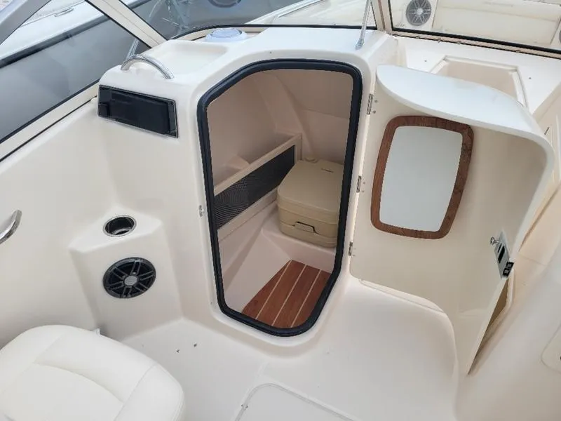 Slide: The Image of 2025 Grady-White Freedom 215 boat interior with storage compartment and seating. - 13