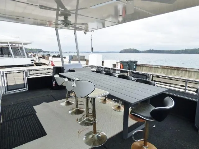 Slide: The Image of Outdoor dining area on 2023 Sumerset 18x90 houseboat with lake view. - 1