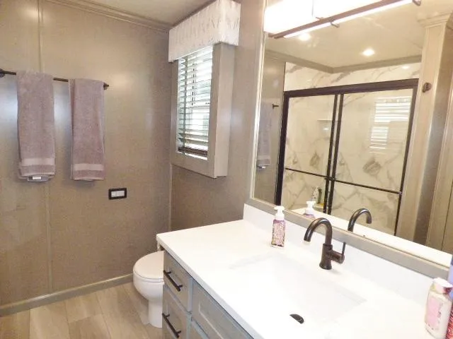 Slide: The Image of Modern bathroom in 2023 Sumerset 18x90 houseboat with glass shower and double vanity. - 10