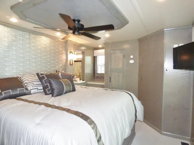 Slide: The Image of Luxurious bedroom in 2023 Sumerset 18x90 houseboat with modern decor and ceiling fan. - 11
