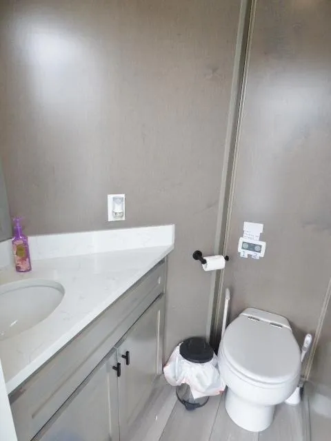 Slide: The Image of Modern bathroom in 2023 Sumerset 18x90 houseboat with sleek fixtures and ample storage. - 13