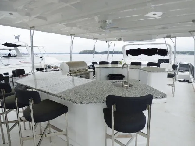 Slide: The Image of Sumerset 18x90 2023 houseboat with outdoor kitchen and seating area. - 16