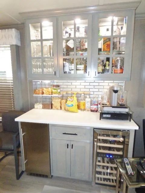 Slide: The Image of Modern bar area in 2023 Sumerset 18x90 houseboat with glass cabinets and countertop snacks. - 5