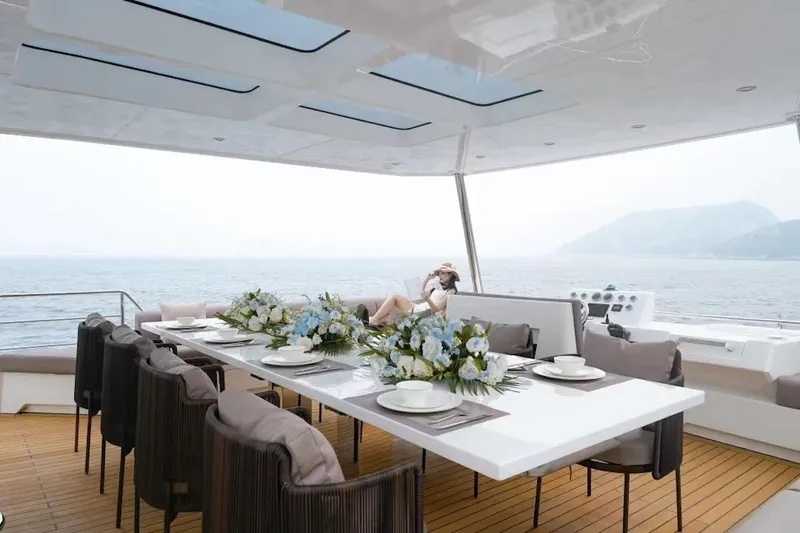 Slide: The Image of Luxurious dining area on 2024 Catamaran Diamond Yachts EF56 with ocean view. - 11
