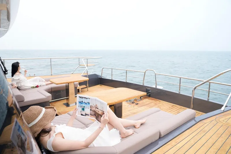 Slide: The Image of Women relaxing on the deck of a 2024 Catamaran Diamond Yachts EF56. - 14
