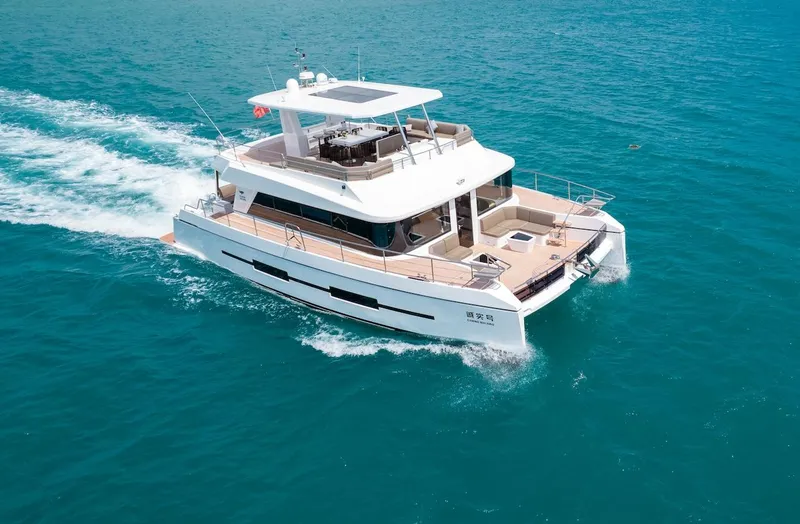 Slide: The Image of 2024 Catamaran Diamond Yachts EF56 cruising on open water. - 2