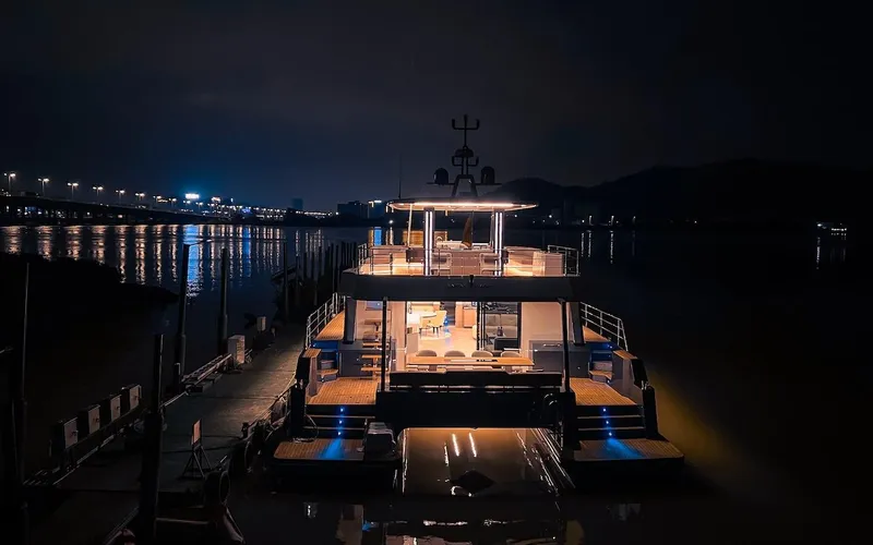 Slide: The Image of 2024 Catamaran Diamond Yachts EF56 illuminated at night, docked in a serene marina. - 29