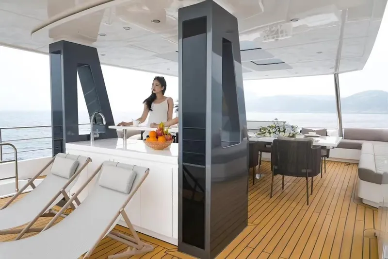 Slide: The Image of Luxury deck of 2024 Catamaran Diamond Yachts EF56 with lounge chairs and dining area. - 9