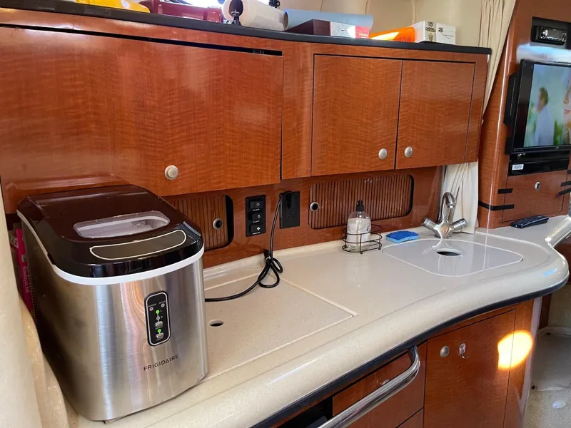 Slide: The Image of 2005 Sea Ray 320 Sundancer yacht interior with kitchenette and appliances. - 12