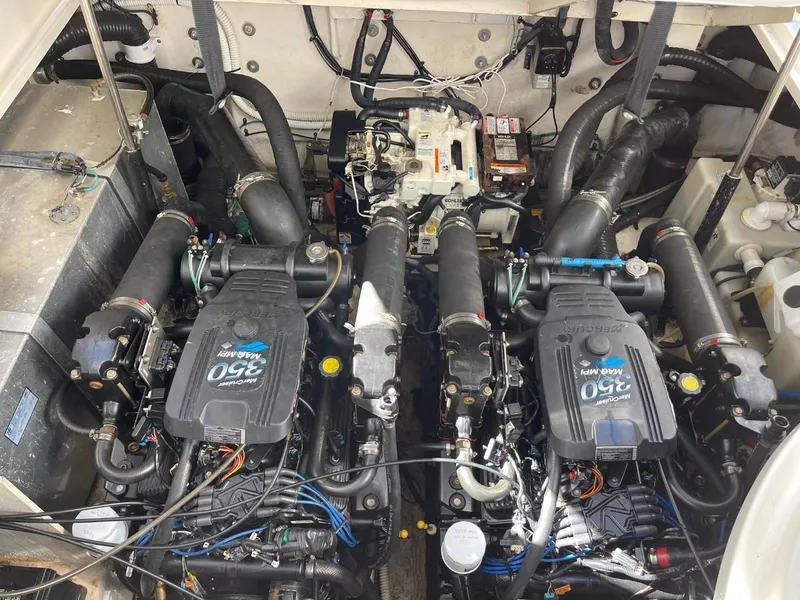 Slide: The Image of Engine compartment of a 2005 Sea Ray 320 Sundancer boat, featuring twin 350 MAG MPI engines. - 14