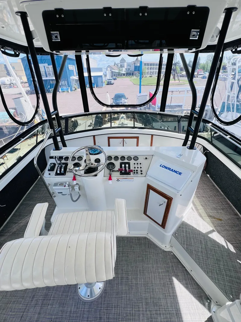 Slide: The Image of Cockpit view of 1987 Carver 4227 Motor Yacht with steering wheel and navigation equipment. - 11