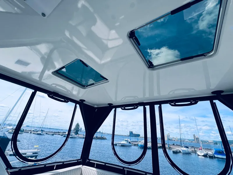 Slide: The Image of Interior view of 1987 Carver 4227 Cockpit Motor Yacht with marina backdrop. - 13