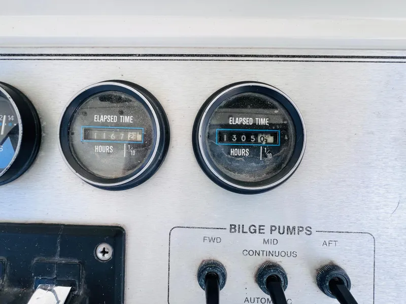 Slide: The Image of Control panel of a 1987 Carver 4227 Cockpit Motor Yacht showing elapsed time and bilge pump switches. - 16