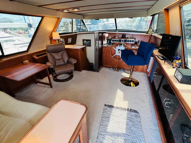 Slide: The Image of Interior of 1987 Carver 4227 Cockpit Motor Yacht with plush seating and helm station. - 17