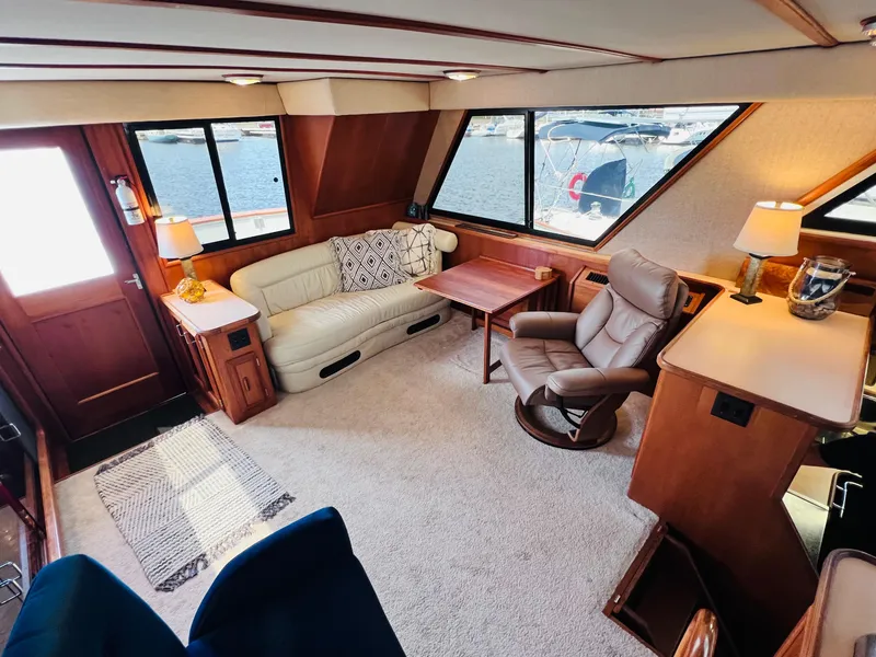 Slide: The Image of Luxurious interior of 1987 Carver 4227 Cockpit Motor Yacht with comfortable seating and scenic windows. - 19