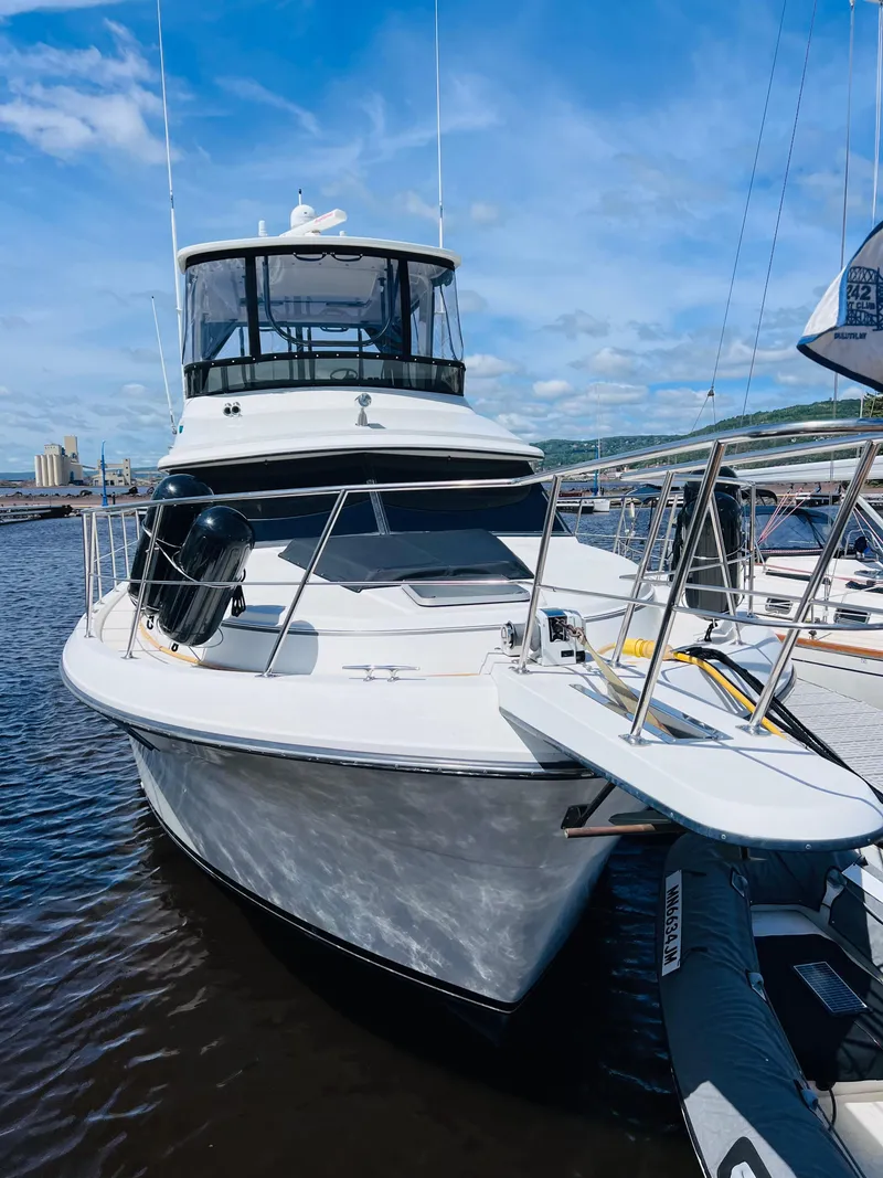 Slide: The Image of 1987 Carver 4227 Cockpit Motor Yacht docked on a sunny day. - 2