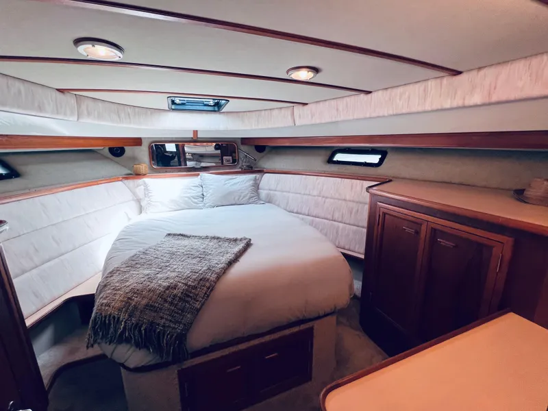 Slide: The Image of Luxurious bedroom interior of 1987 Carver 4227 Cockpit Motor Yacht with cozy bed and wood accents. - 22