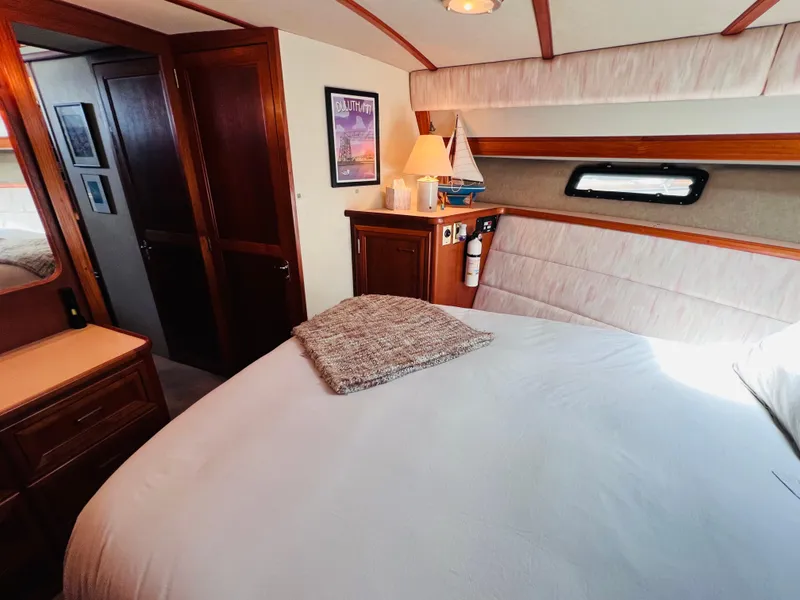 Slide: The Image of Luxurious bedroom interior of 1987 Carver 4227 Cockpit Motor Yacht with cozy decor. - 24