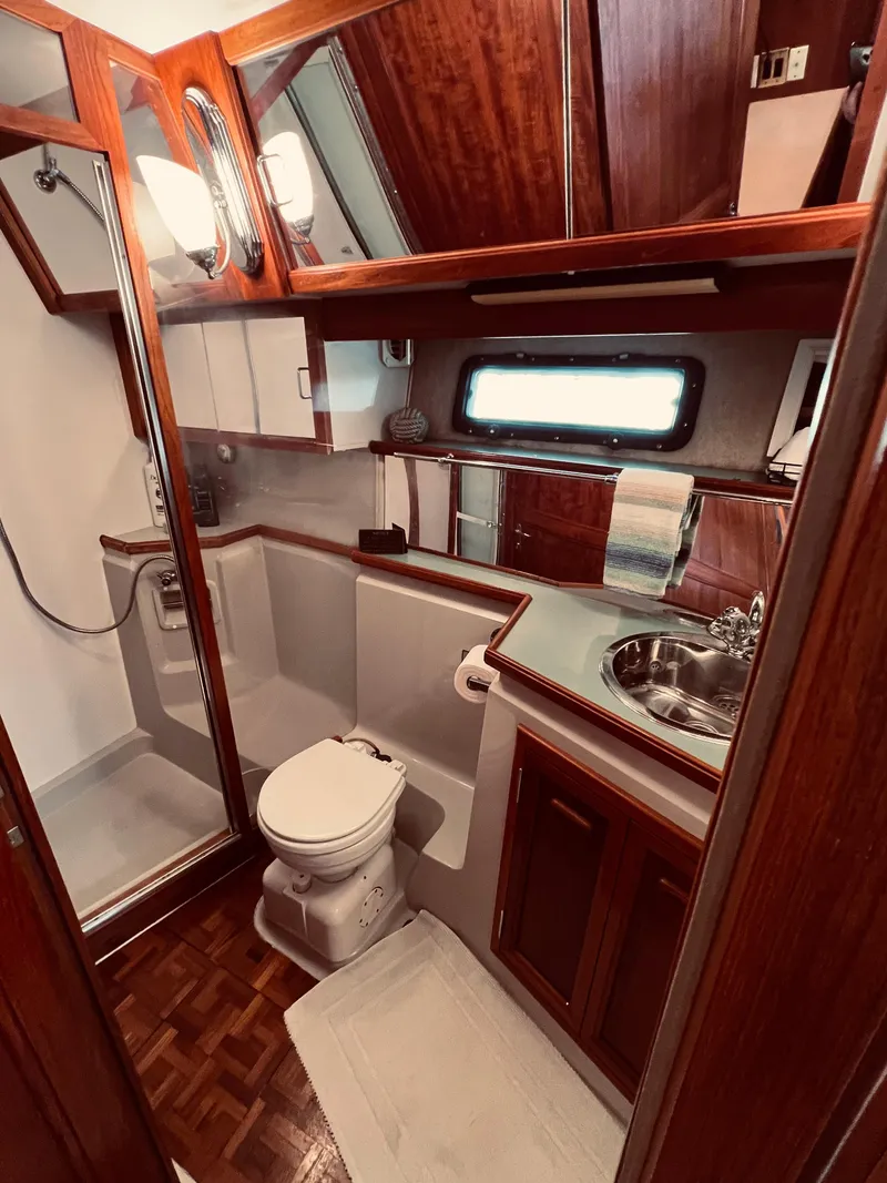 Slide: The Image of 1987 Carver 4227 Cockpit Motor Yacht bathroom with wood accents and modern fixtures. - 25