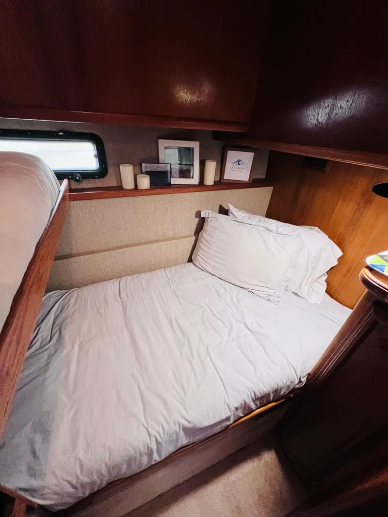 Slide: The Image of Cozy cabin interior of 1987 Carver 4227 Cockpit Motor Yacht with bed and decor. - 26