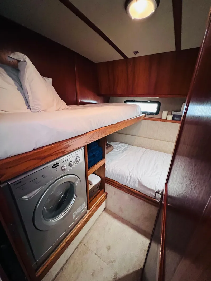 Slide: The Image of Interior of 1987 Carver 4227 Cockpit Motor Yacht with bunk beds and washing machine. - 27