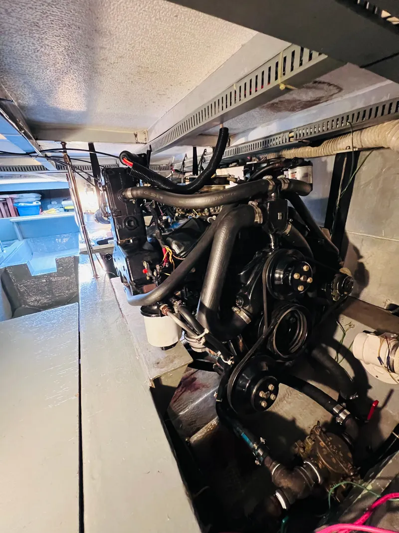 Slide: The Image of Engine room of 1987 Carver 4227 Cockpit Motor Yacht, showcasing mechanical components. - 29