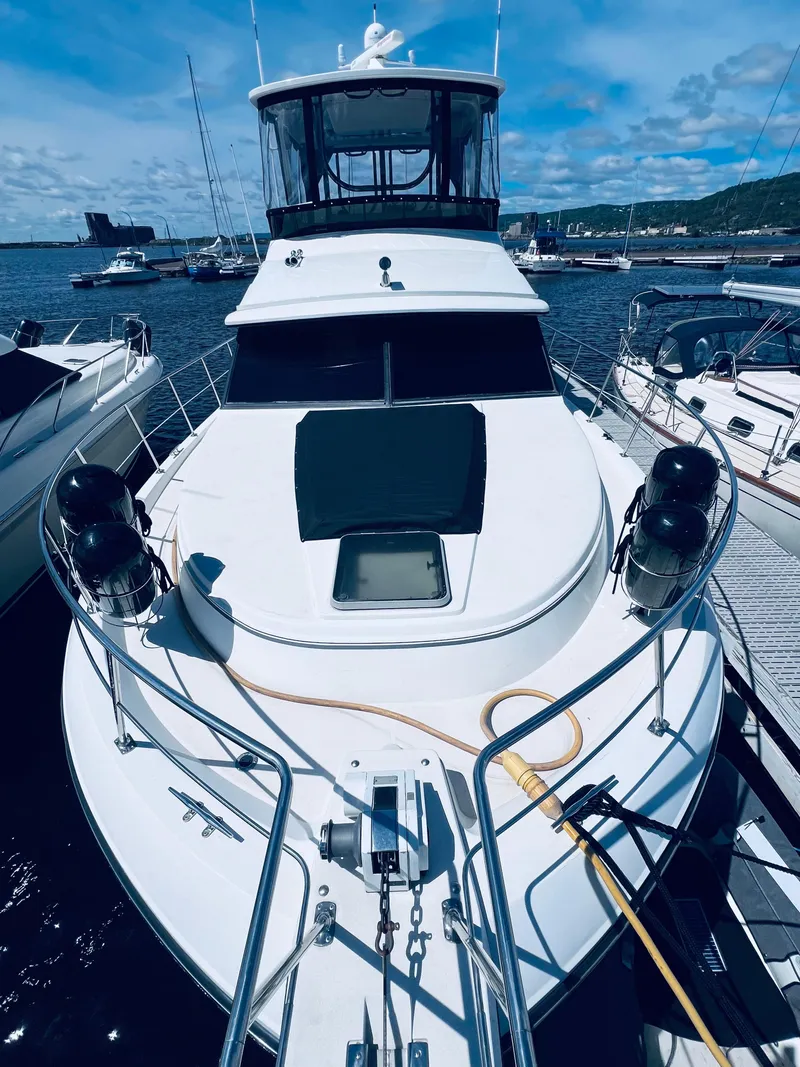 Slide: The Image of 1987 Carver 4227 Cockpit Motor Yacht docked at marina under blue sky. - 3