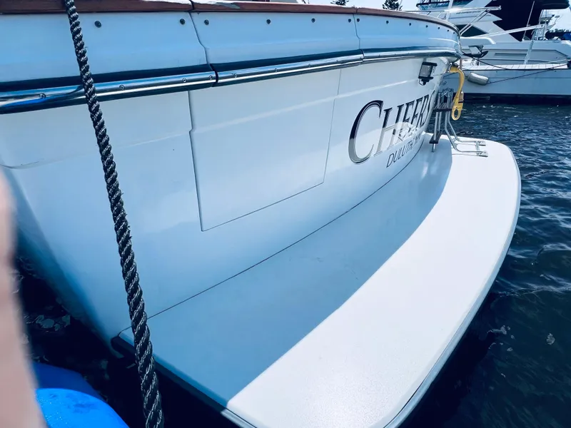 Slide: The Image of 1987 Carver 4227 Cockpit Motor Yacht docked, showing rear deck and water reflection. - 9