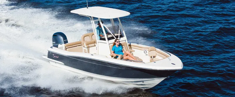 Slide: The Image of 2025 Scout 210 XSF boat cruising on open water. - 1