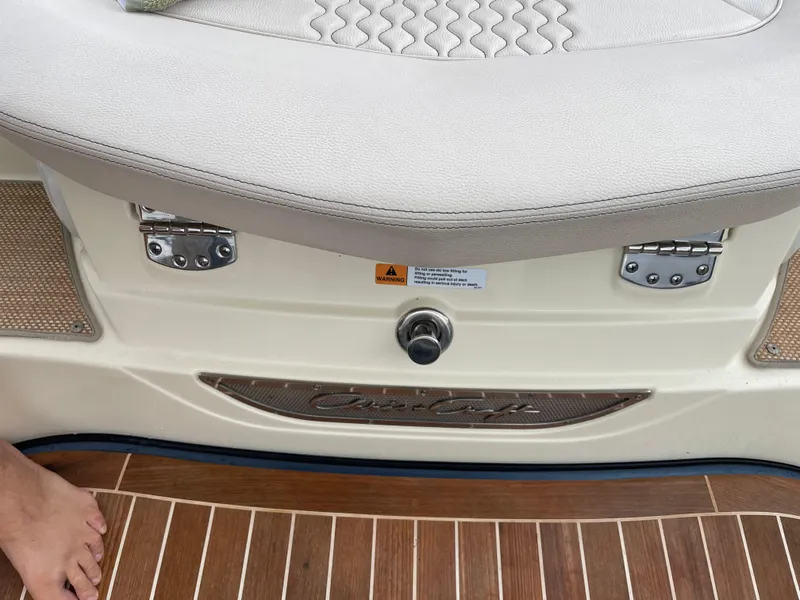 Slide: The Image of Chris-Craft 28 Launch GT 2021 boat interior, featuring cushioned seating and teak flooring. - 32