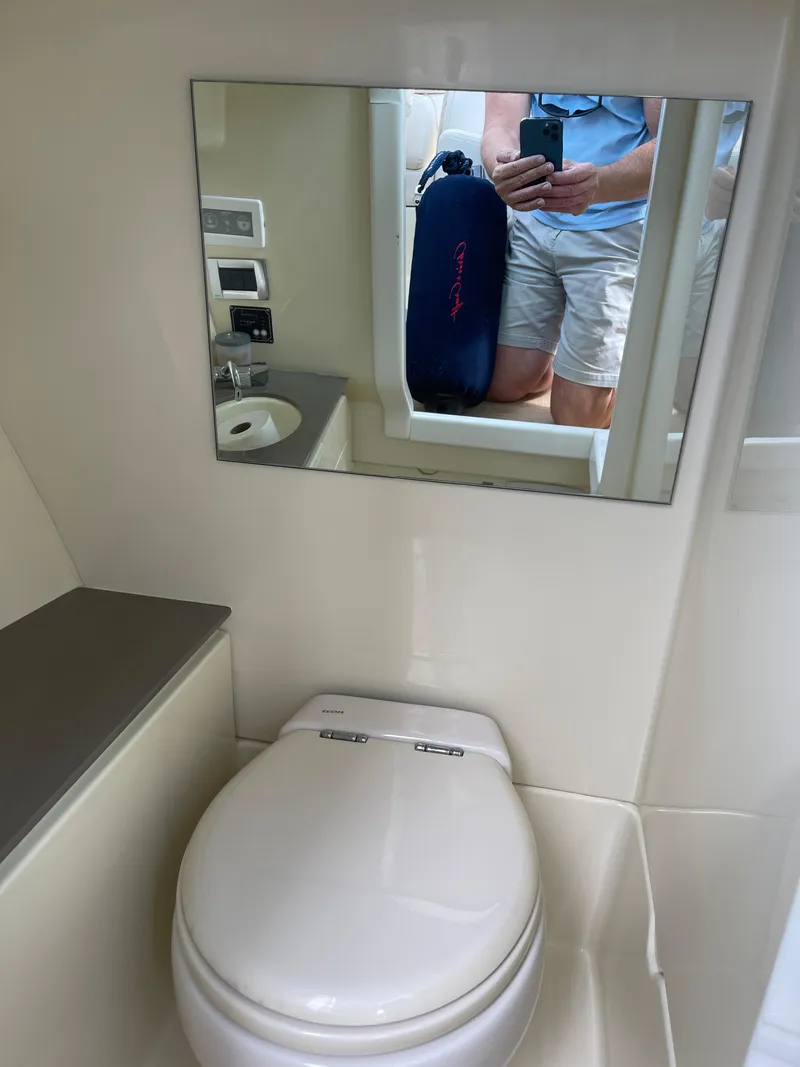 Slide: The Image of 2021 Chris-Craft 28 Launch GT boat bathroom with mirror and toilet. - 34