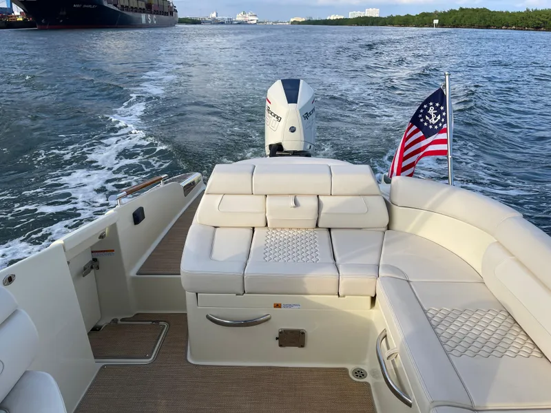 Slide: The Image of 2021 Chris-Craft 28 LAUNCH GT boat with American flag, cruising on water. - 42