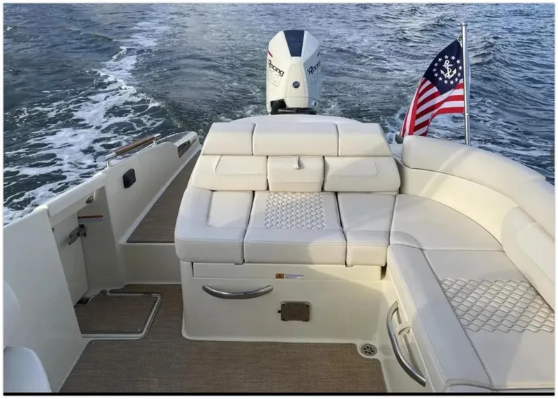Slide: The Image of 2021 Chris-Craft 28 Launch GT boat with luxurious seating and American flag. - 45