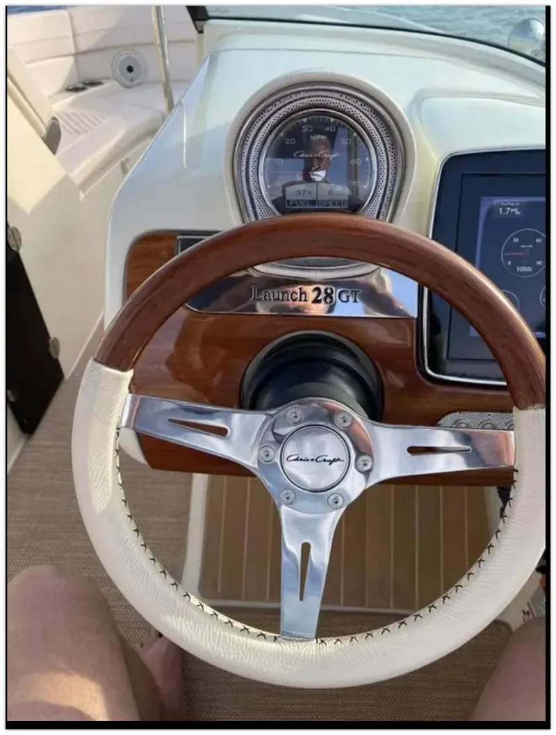 Slide: The Image of Steering wheel and dashboard of a 2021 Chris-Craft 28 Launch GT boat. - 46
