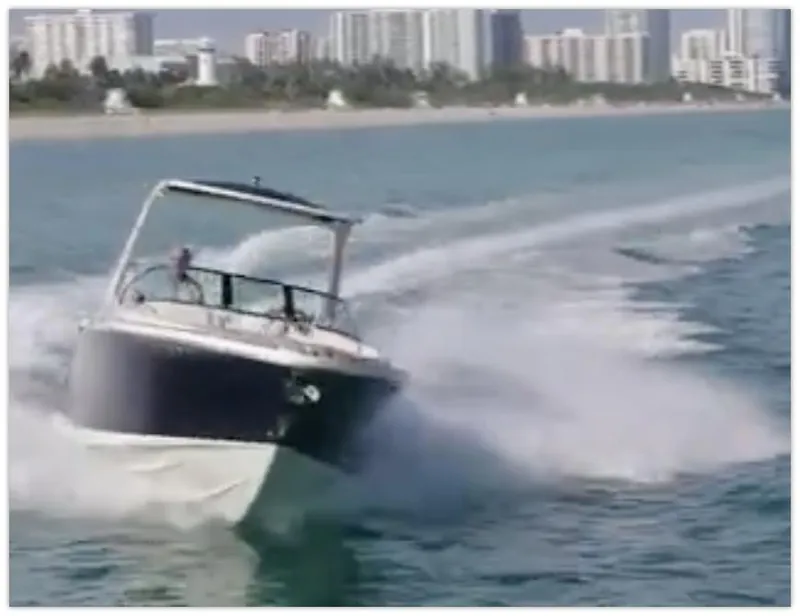 Slide: The Image of 2021 Chris-Craft 28 LAUNCH GT cruising on water near city skyline. - 7