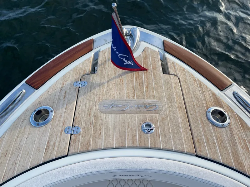 Slide: The Image of 2021 Chris-Craft 28 Launch GT boat deck with flag and wood finish. - 9