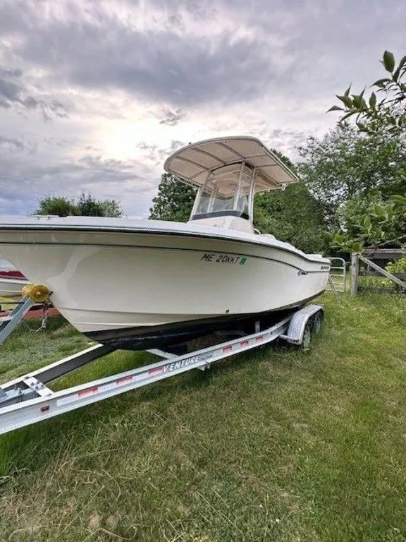 Slide: The Image of 2016 Grady-White 209 Fisherman boat on a trailer in a grassy area. - 1
