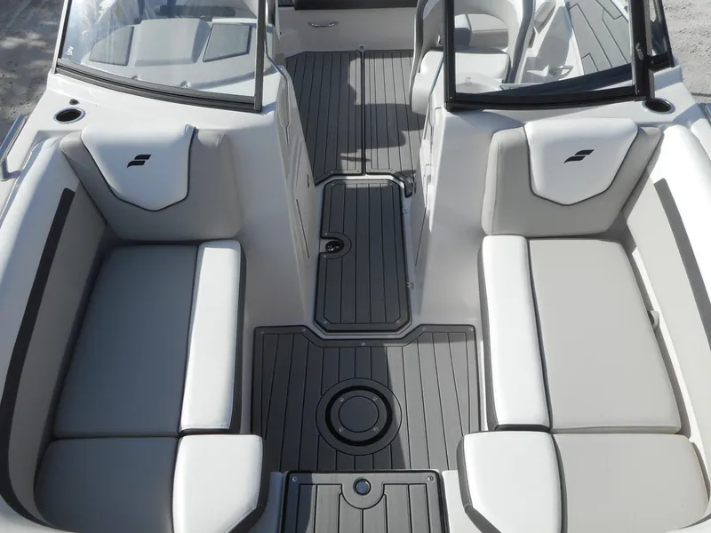 Slide: The Image of 2024 Starcraft SVX 210 OB DC boat interior with gray and white seating. - 10