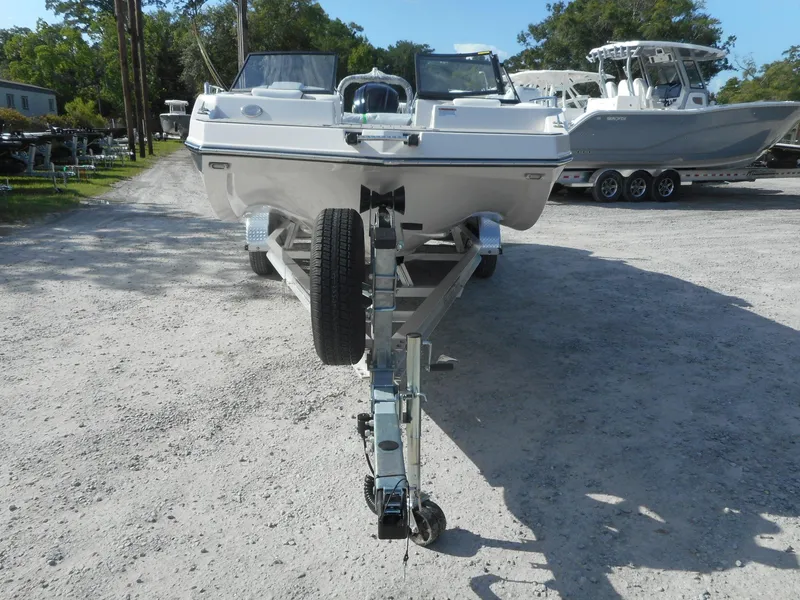 Slide: The Image of 2024 Starcraft SVX 210 OB DC boat on a trailer, front view. - 12
