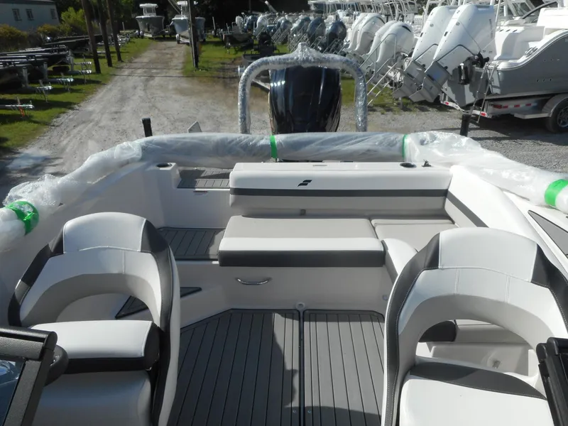 Slide: The Image of 2024 Starcraft SVX 210 OB DC boat interior with seating and deck view. - 3