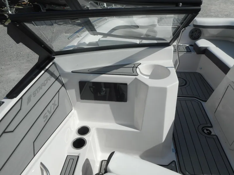 Slide: The Image of 2024 Starcraft SVX 210 OB DC boat interior with seating and cup holders. - 5