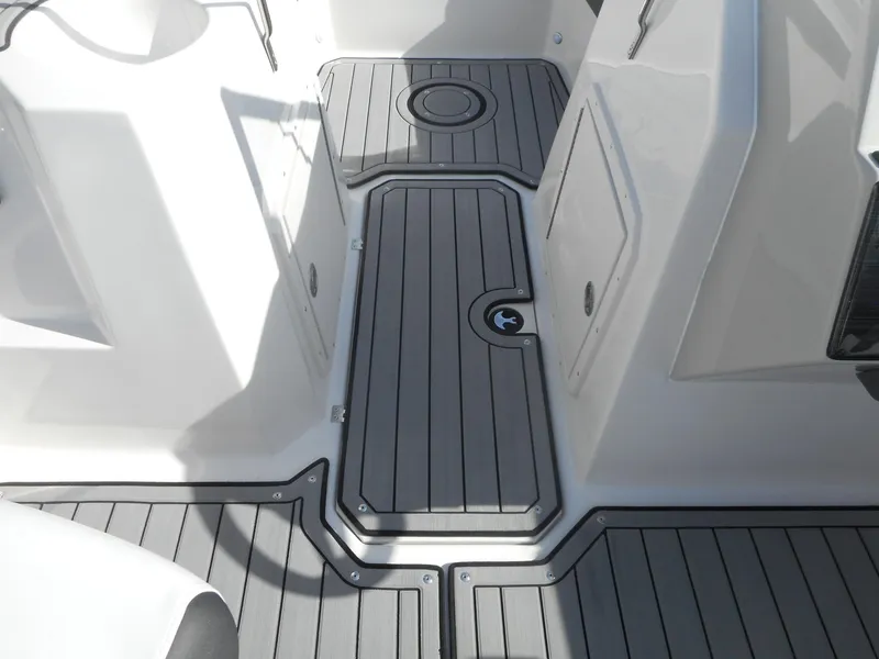 Slide: The Image of 2024 Starcraft SVX 210 OB DC boat deck with gray non-slip flooring. - 6